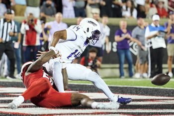 Louisville Cardinals defensive lineman Clev Lubin (50) strips the ball away from James Madison Dukes quarterback Alonza Barnett III (14) that set up a fumble and recovery touchdown by Louisville Cardinals defensive lineman AJ Green (17) at L&N Credit Union Stadium in Louisville, Kentucky. Sept. 5, 2025