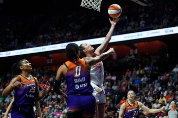 Sep 6, 2025; Uncasville, Connecticut, USA; Connecticut Sun guard Marina Mabrey (3) scores against Phoenix Mercury forward Satou Sabally (0) in the first half at Mohegan Sun Arena. Mandatory Credit: David Butler II-Imagn Images