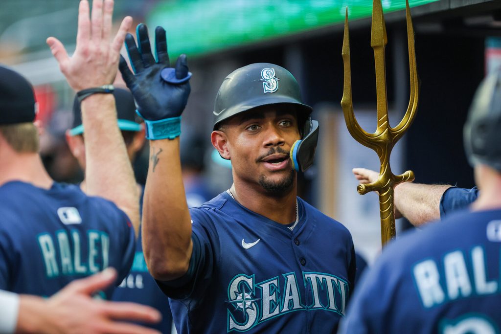 Sep 6, 2025; Cumberland, Georgia, USA; Seattle Mariners outfielder Julio Rodriguez (44) celebrates with teammates in the dugout after scoring against the Atlanta Braves during the first inning at Truist Park. Mandatory Credit: Jordan Godfree-Imagn Images