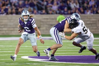 Sep 6, 2025; Manhattan, Kansas, USA; Kansas State Wildcats quarterback Avery Johnson (2) looks for room to run during the third quarter against the Army Black Knights at Bill Snyder Family Football Stadium. Mandatory Credit: Scott Sewell-Imagn Images