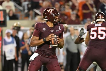 Sep 6, 2025; Blacksburg, Virginia, USA;  Virginia Tech Hokies quarterback Kyron Drones (1) looks to pass the ball during the fourth quarter at Lane Stadium. Mandatory Credit: Brian Bishop-Imagn Images