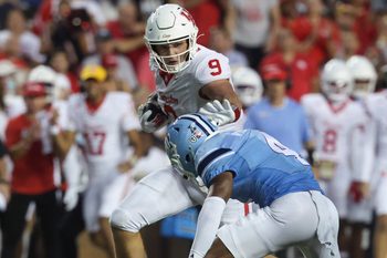 Sep 6, 2025; Houston, Texas, USA; Houston Cougars tight end Tanner Koziol (9) runs with the ball as Rice Owls safety Marcus Williams (4) attempts to make a tackle during the third quarter at Rice Stadium. Mandatory Credit: Troy Taormina-Imagn Images