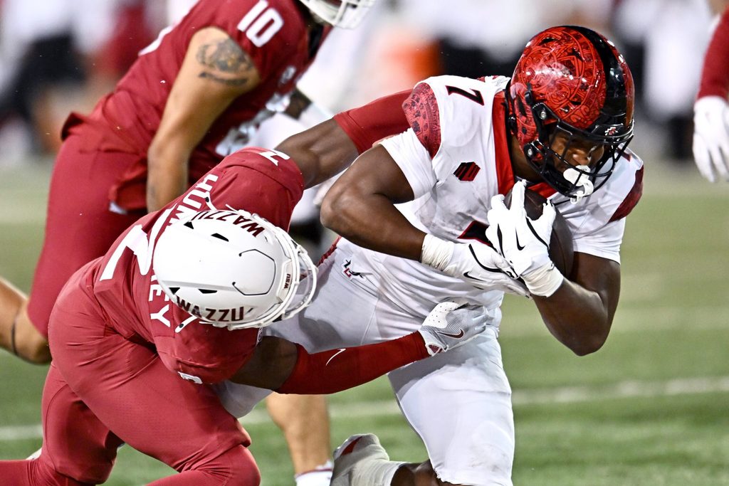 Sep 6, 2025; Pullman, Washington, USA; San Diego State Aztecs running back Lucky Sutton (7) is tackled by Washington State Cougars cornerback Colby Humphrey (2) in the second half at Gesa Field at Martin Stadium. Mandatory Credit: James Snook-Imagn Images