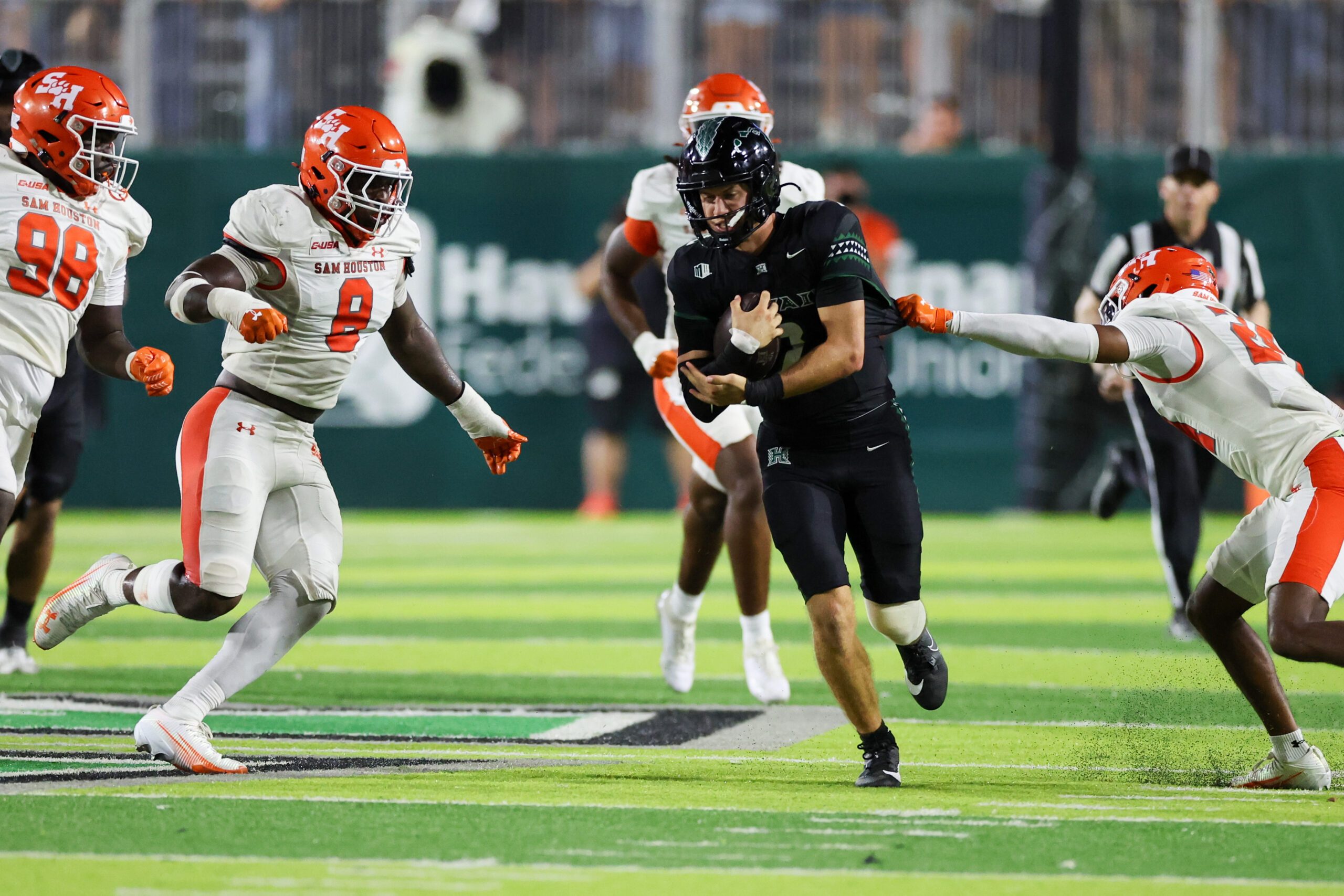 Sep 6, 2025; Honolulu, Hawaii, USA;  Hawaii Rainbow Warriors quarterback Luke Weaver (2) weaves through the Sam Houston Bearkats defense during the third quarter at Clarence T.C. Ching Athletics Complex. Mandatory Credit: Marco Garcia-Imagn Images