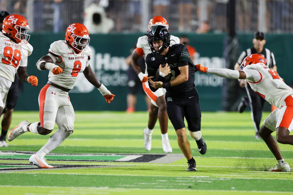 Sep 6, 2025; Honolulu, Hawaii, USA; Hawaii Rainbow Warriors quarterback Luke Weaver (2) weaves through the Sam Houston Bearkats defense during the third quarter at Clarence T.C. Ching Athletics Complex. Mandatory Credit: Marco Garcia-Imagn Images
