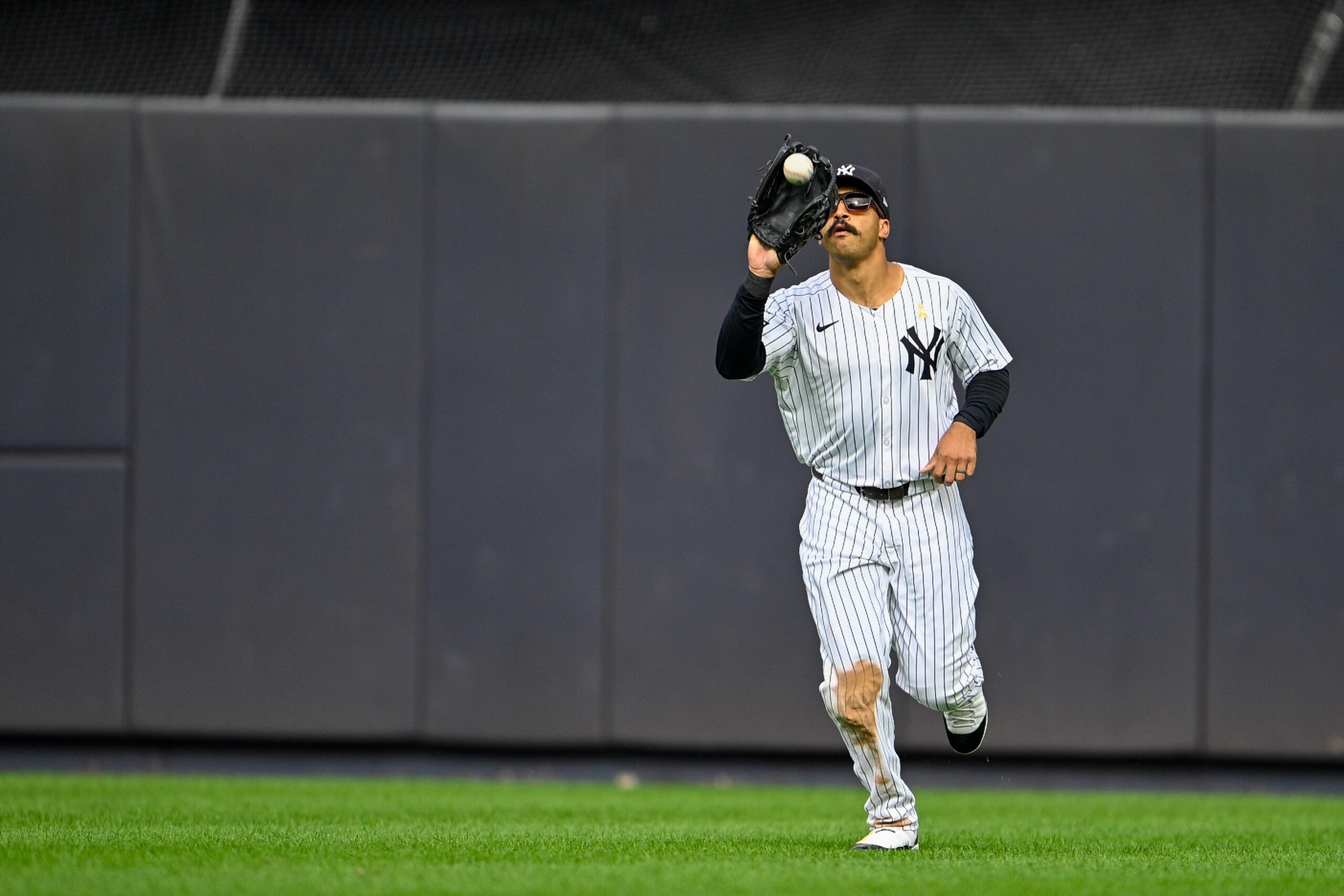 Sep 7, 2025; Bronx, New York, USA; New York Yankees center fielder Trent Grisham (12) catches a fly ball during the ninth inning against the Toronto Blue Jays at Yankee Stadium. Mandatory Credit: Mark Smith-Imagn Images