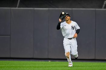 Sep 7, 2025; Bronx, New York, USA; New York Yankees center fielder Trent Grisham (12) catches a fly ball during the ninth inning against the Toronto Blue Jays at Yankee Stadium. Mandatory Credit: Mark Smith-Imagn Images