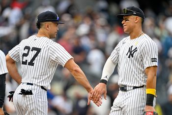 Sep 7, 2025; Bronx, New York, USA; New York Yankees designated hitter Giancarlo Stanton (27) celebrates with New York Yankees right fielder Aaron Judge (99) after the game against the Toronto Blue Jays at Yankee Stadium. Mandatory Credit: Mark Smith-Imagn Images