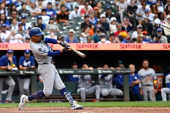 Sep 7, 2025; Baltimore, Maryland, USA;  Los Angeles Dodgers shortstop Mookie Betts (50) hits a rbi single in the ninth inning against the Baltimore Orioles  at Oriole Park at Camden Yards. Mandatory Credit: Tommy Gilligan-Imagn Images