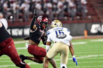 Aggie Kadarius Calloway (1) attempts to get around a Tulsa defender as NMSU took on the University of Tulsa Golden Hurricane on Saturday in Las Cruces.