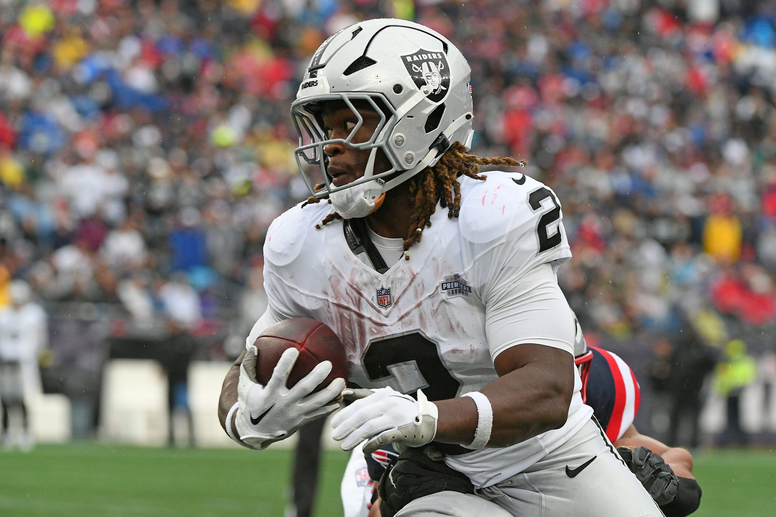 Sep 7, 2025; Foxborough, Massachusetts, USA; Las Vegas Raiders running back Ashton Jeanty (2) rushes the ball against the New England Patriots during the second half at Gillette Stadium. Mandatory Credit: Bob DeChiara-Imagn Images