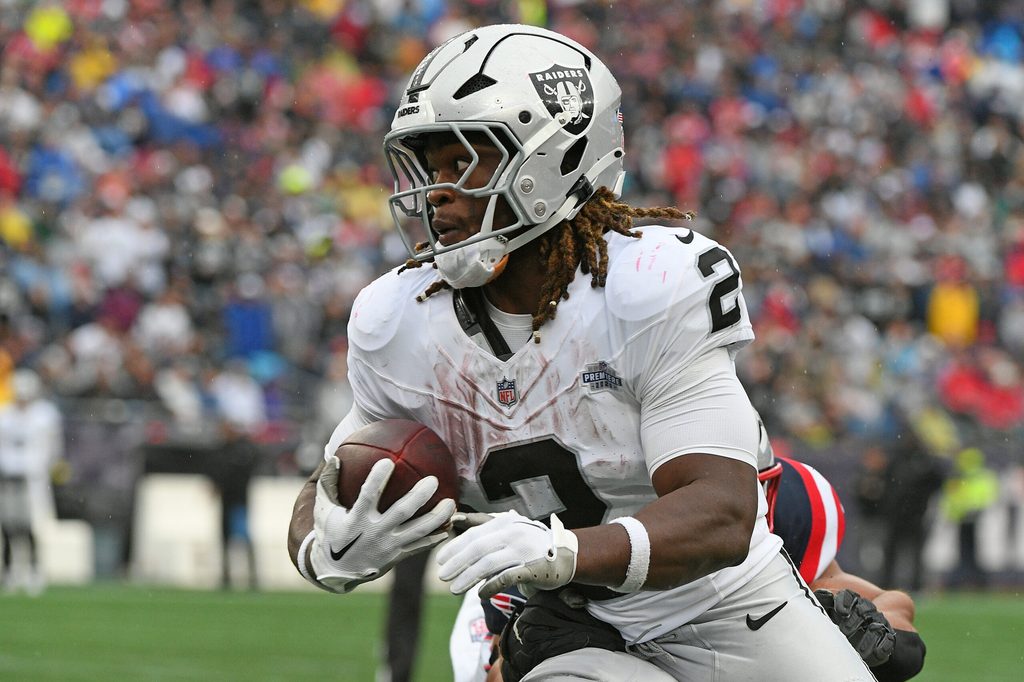 Sep 7, 2025; Foxborough, Massachusetts, USA; Las Vegas Raiders running back Ashton Jeanty (2) rushes the ball against the New England Patriots during the second half at Gillette Stadium. Mandatory Credit: Bob DeChiara-Imagn Images