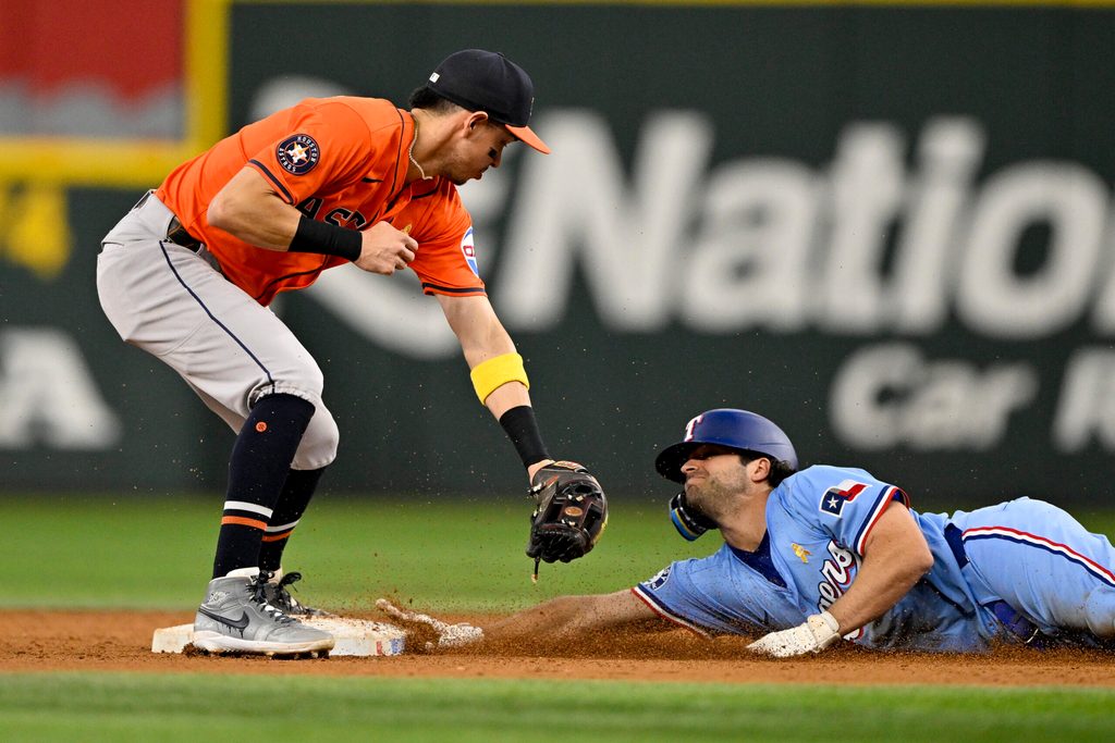 Sep 7, 2025; Arlington, Texas, USA; at Texas Rangers shortstop Josh Smith (8) slides under the tag of Houston Astros second baseman Mauricio Dubon (14) as he steals second base during the eighth inning at Globe Life Field. Mandatory Credit: Jerome Miron-Imagn Images