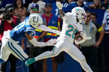 Sep 7, 2025; Indianapolis, Indiana, USA; Indianapolis Colts safety Camryn Bynum (0) pushes Miami Dolphins running back De'Von Achane (28) during the second half of a game at Lucas Oil Stadium. Mandatory Credit: Christine Tannous-USA TODAY Network via Imagn Images