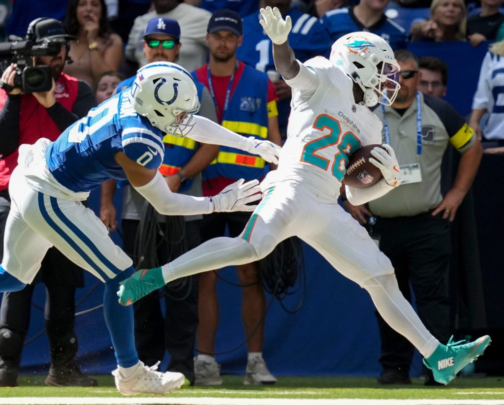 Sep 7, 2025; Indianapolis, Indiana, USA; Indianapolis Colts safety Camryn Bynum (0) pushes Miami Dolphins running back De'Von Achane (28) during the second half of a game at Lucas Oil Stadium. Mandatory Credit: Christine Tannous-USA TODAY Network via Imagn Images