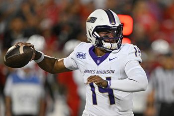 Sep 5, 2025; Louisville, Kentucky, USA;  James Madison Dukes quarterback Alonza Barnett III (14) looks to pass against the Louisville Cardinals during the first half at L&N Federal Credit Union Stadium. Louisville defeated James Madison 28-14. Mandatory Credit: Jamie Rhodes-Imagn Images