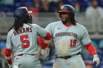 Sep 8, 2025; Miami, Florida, USA; Washington Nationals first baseman Josh Bell (19) celebrates with shortstop CJ Abrams (5) after hitting a two-run home run against the Miami Marlins during the sixth inning at loanDepot Park. Mandatory Credit: Sam Navarro-Imagn Images