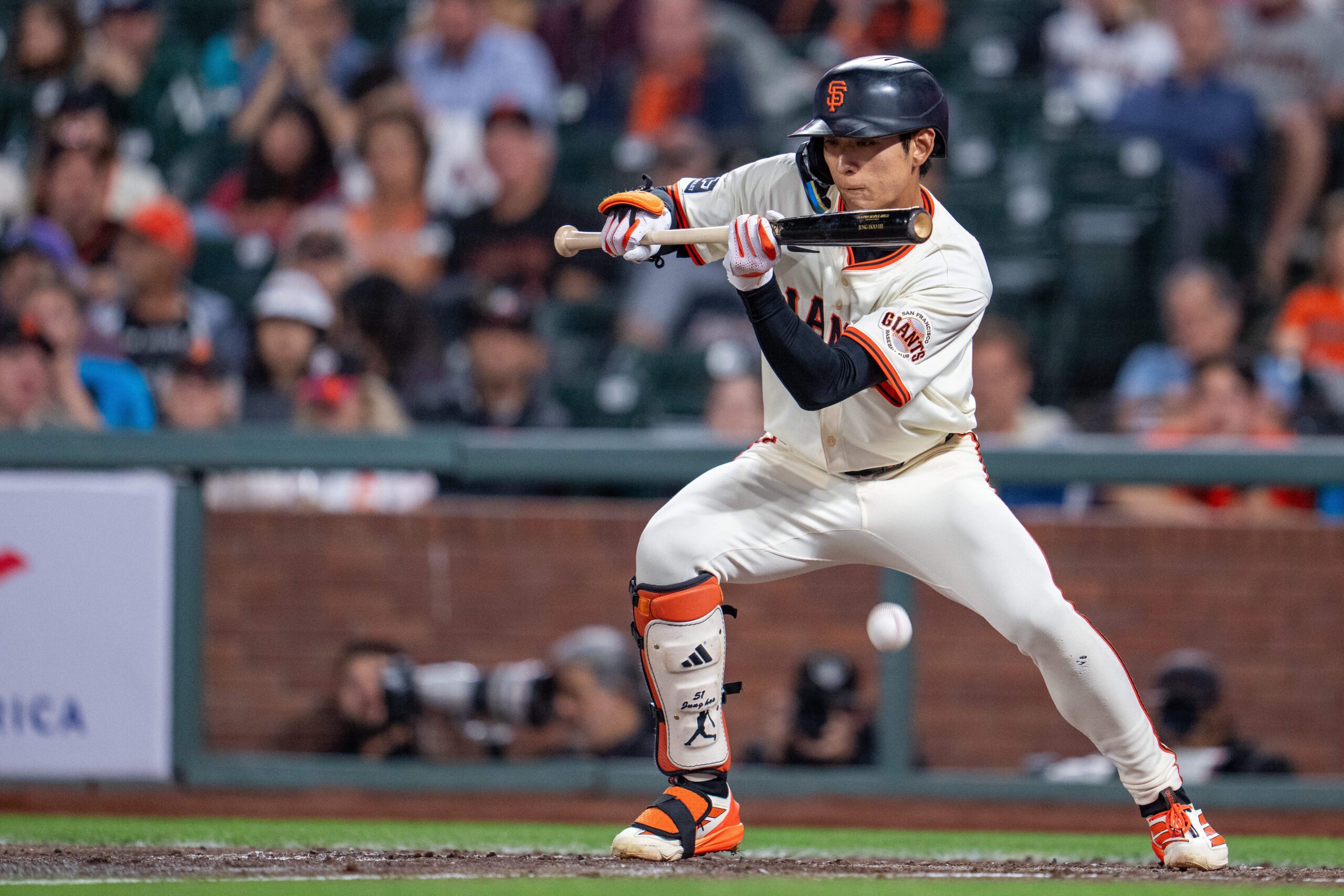 Sep 8, 2025; San Francisco, California, USA; San Francisco Giants center fielder Jung Hoo Lee (51) bunt hits to load the bases against the Arizona Diamondbacks during the sixth inning at Oracle Park. Mandatory Credit: Neville E. Guard-Imagn Images