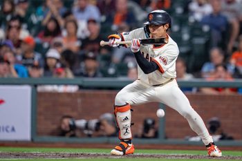 Sep 8, 2025; San Francisco, California, USA; San Francisco Giants center fielder Jung Hoo Lee (51) bunt hits to load the bases against the Arizona Diamondbacks during the sixth inning at Oracle Park. Mandatory Credit: Neville E. Guard-Imagn Images