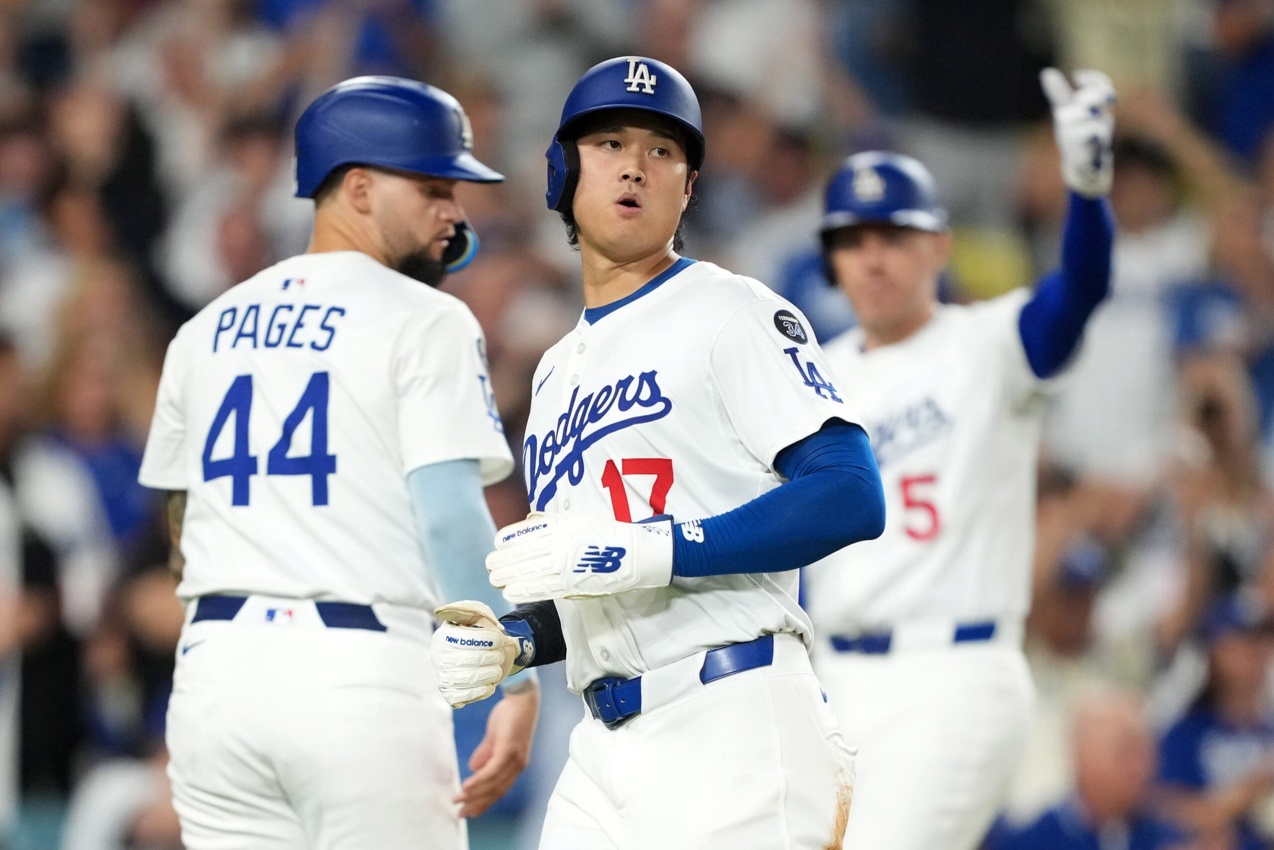 Sep 8, 2025; Los Angeles, California, USA; Los Angeles Dodgers designated hitter Shohei Ohtani (17) scores in the seventh inning against the Colorado Rockies as Dodgers center fielder Andy Pages (44) and first baseman Freddie Freeman (5) watch at Dodger Stadium. Mandatory Credit: Kirby Lee-Imagn Images