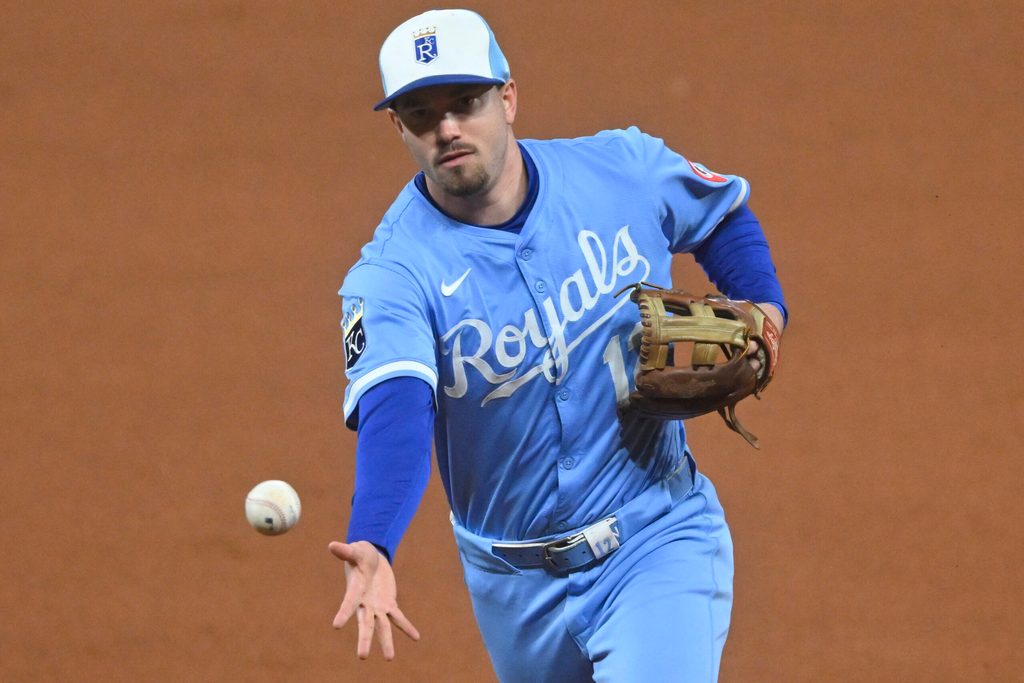 Sep 9, 2025; Cleveland, Ohio, USA; Kansas City Royals second baseman Nick Loftin (12) tosses the ball to first base in the seventh inning against the Cleveland Guardians at Progressive Field. Mandatory Credit: David Richard-Imagn Images