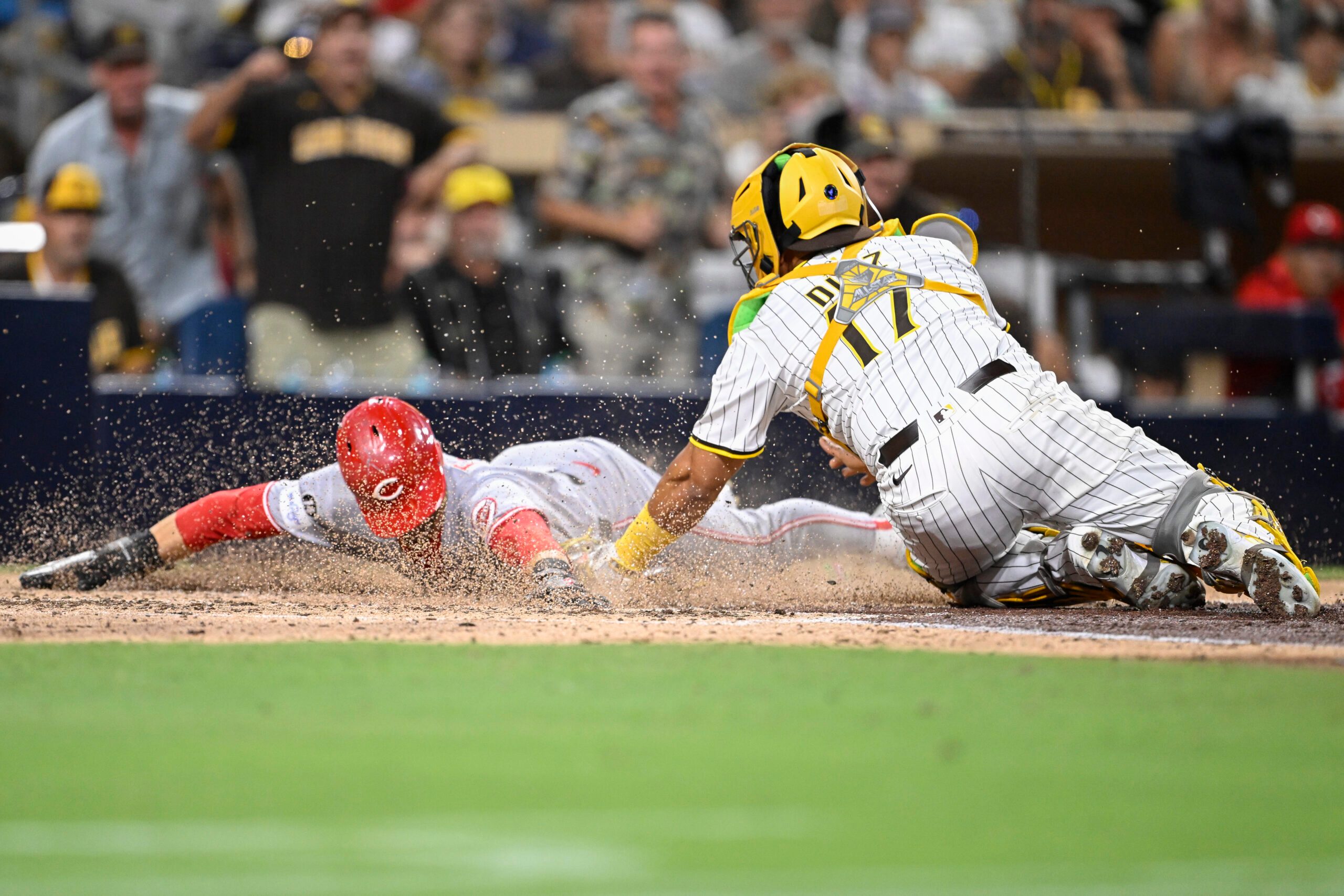 Sep 10, 2025; San Diego, California, USA; Cincinnati Reds center fielder TJ Friedl (29) scores ahead tag of San Diego Padres catcher Elias Diaz (17) during the eighth inning at Petco Park. Mandatory Credit: Denis Poroy-Imagn Images