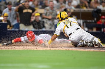 Sep 10, 2025; San Diego, California, USA; Cincinnati Reds center fielder TJ Friedl (29) scores ahead tag of San Diego Padres catcher Elias Diaz (17) during the eighth inning at Petco Park. Mandatory Credit: Denis Poroy-Imagn Images