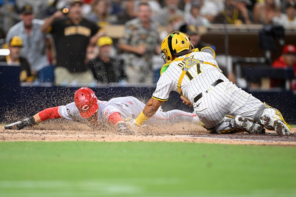 Sep 10, 2025; San Diego, California, USA; Cincinnati Reds center fielder TJ Friedl (29) scores ahead tag of San Diego Padres catcher Elias Diaz (17) during the eighth inning at Petco Park. Mandatory Credit: Denis Poroy-Imagn Images
