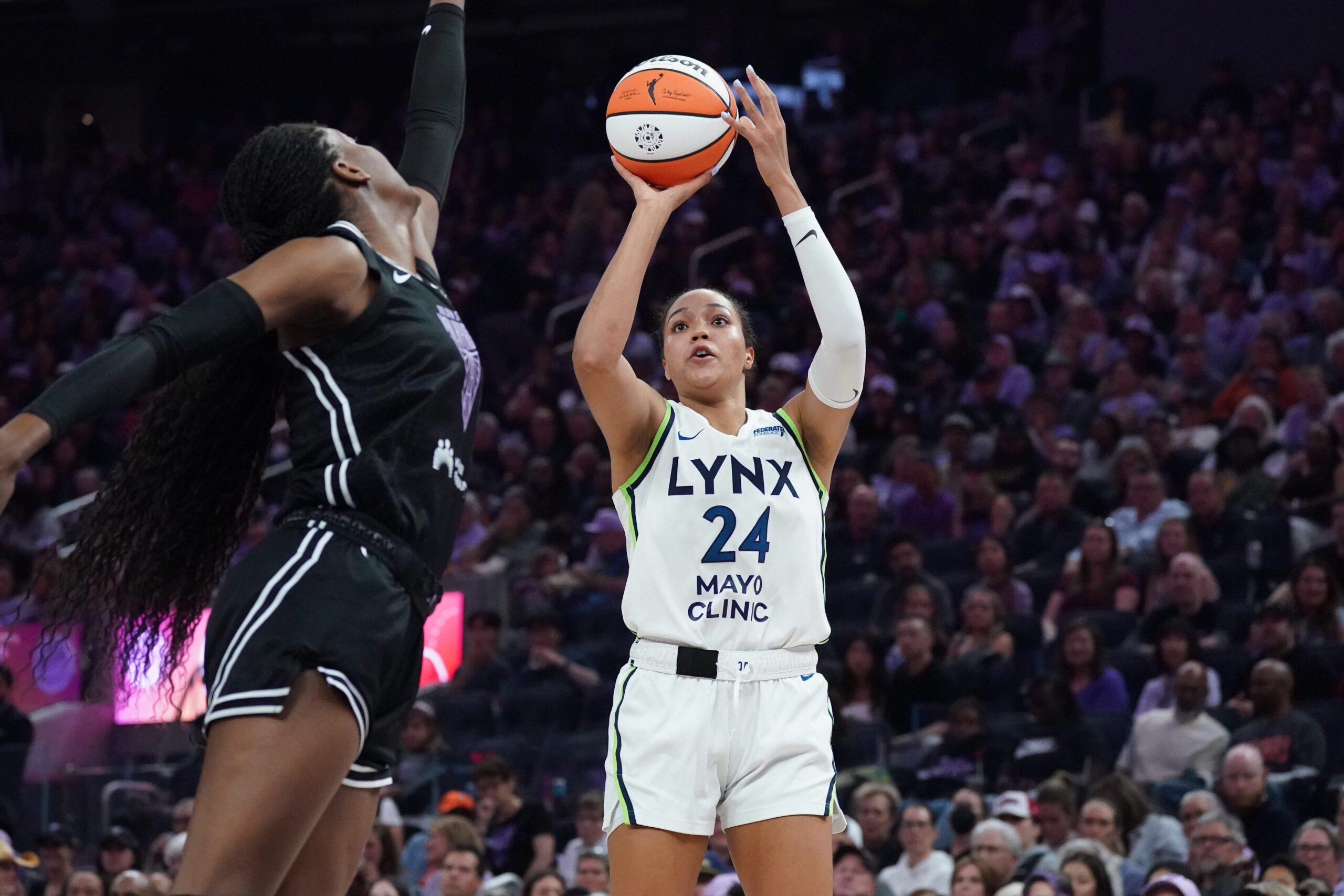 Sep 6, 2025; San Francisco, California, USA;  Minnesota Lynx forward Napheesa Collier (24) shoots over Golden State Valkyries center Temi Fagbenle (14) in the second quarter at Chase Center. Mandatory Credit: David Gonzales-Imagn Images