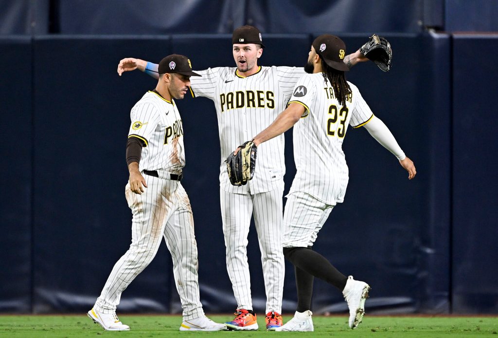 Sep 11, 2025; San Diego, California, USA; San Diego Padres right fielder Ramon Laureano (5), left, Jackson Merrill (3), center, and Fernando Tatis Jr. (23) celebrate after the Padres defeated the Colorado Rockies at Petco Park. Mandatory Credit: Denis Poroy-Imagn Images