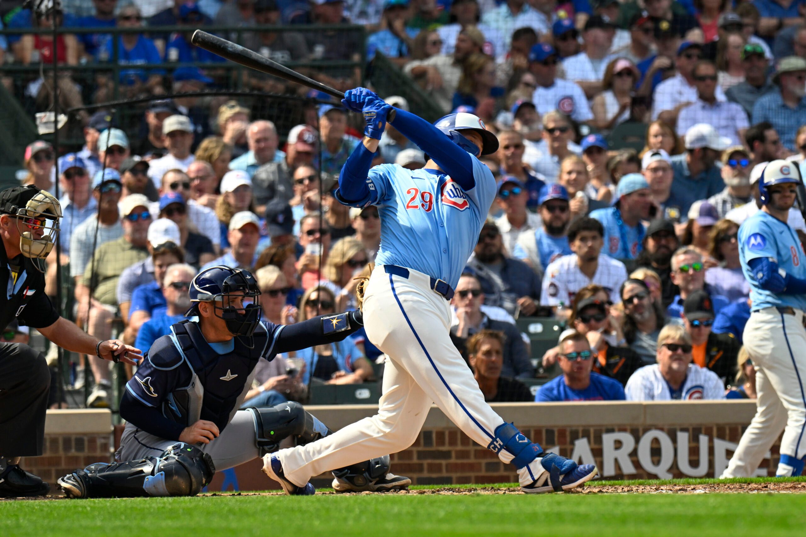 Sep 12, 2025; Chicago, Illinois, USA;  Chicago Cubs first baseman Michael Busch (29) hits an RBI single against the Tampa Bay Rays during the second inning at Wrigley Field. Mandatory Credit: Matt Marton-Imagn Images