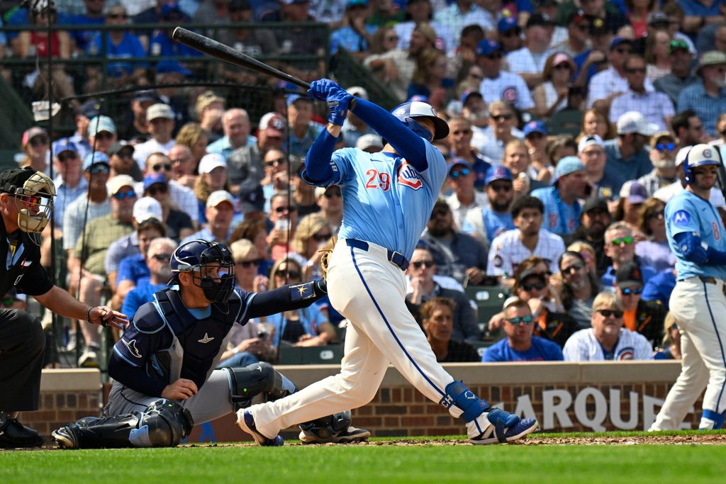 Sep 12, 2025; Chicago, Illinois, USA; Chicago Cubs first baseman Michael Busch (29) hits an RBI single against the Tampa Bay Rays during the second inning at Wrigley Field. Mandatory Credit: Matt Marton-Imagn Images