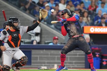 Sep 12, 2025; Toronto, Ontario, CAN; Toronto Blue Jays right fielder George Springer (4) manages to get out of the way of a high pitch against the Baltimore Orioles during the eighth inning at Rogers Centre. Mandatory Credit: Nick Turchiaro-Imagn Images