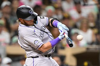 Sep 12, 2025; San Diego, California, USA; Colorado Rockies catcher Hunter Goodman (15) hits a single during the fourth inning against the San Diego Padres at Petco Park. Mandatory Credit: Denis Poroy-Imagn Images