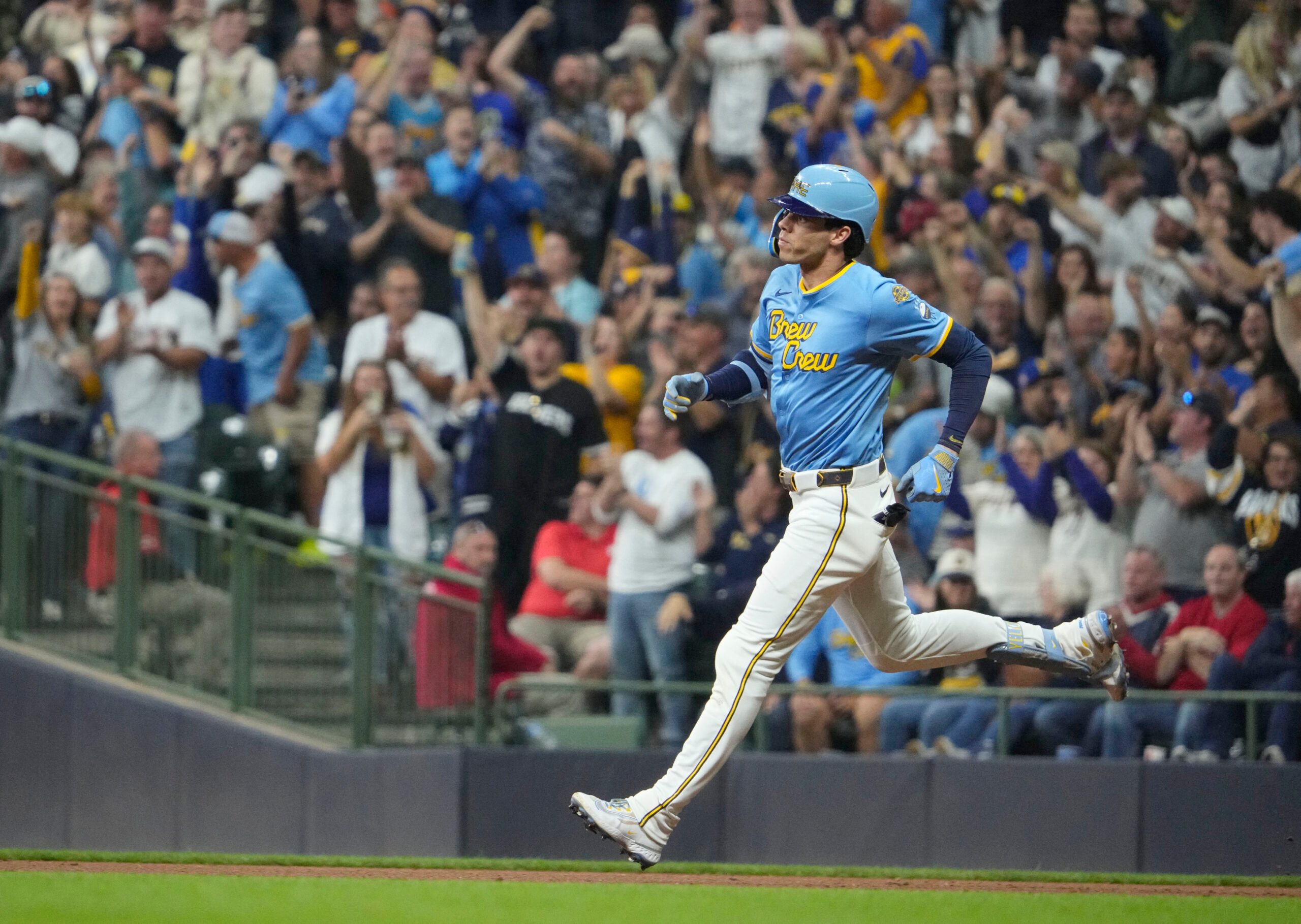 Sep 12, 2025; Milwaukee, Wisconsin, USA; Milwaukee Brewers outfielder Christian Yelich (22) hits a home run against the St. Louis Cardinals in the seventh inning at American Family Field. Mandatory Credit: Michael McLoone-Imagn Images