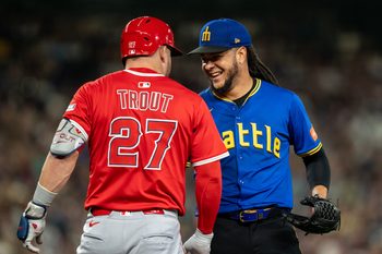 Sep 12, 2025; Seattle, Washington, USA; Seattle Mariners starting pitcher Luis Castillo (58) jokes with Los Angeles Angels designated hitter Mike Trout (27) during the sixth inning at T-Mobile Park. Mandatory Credit: Stephen Brashear-Imagn Images