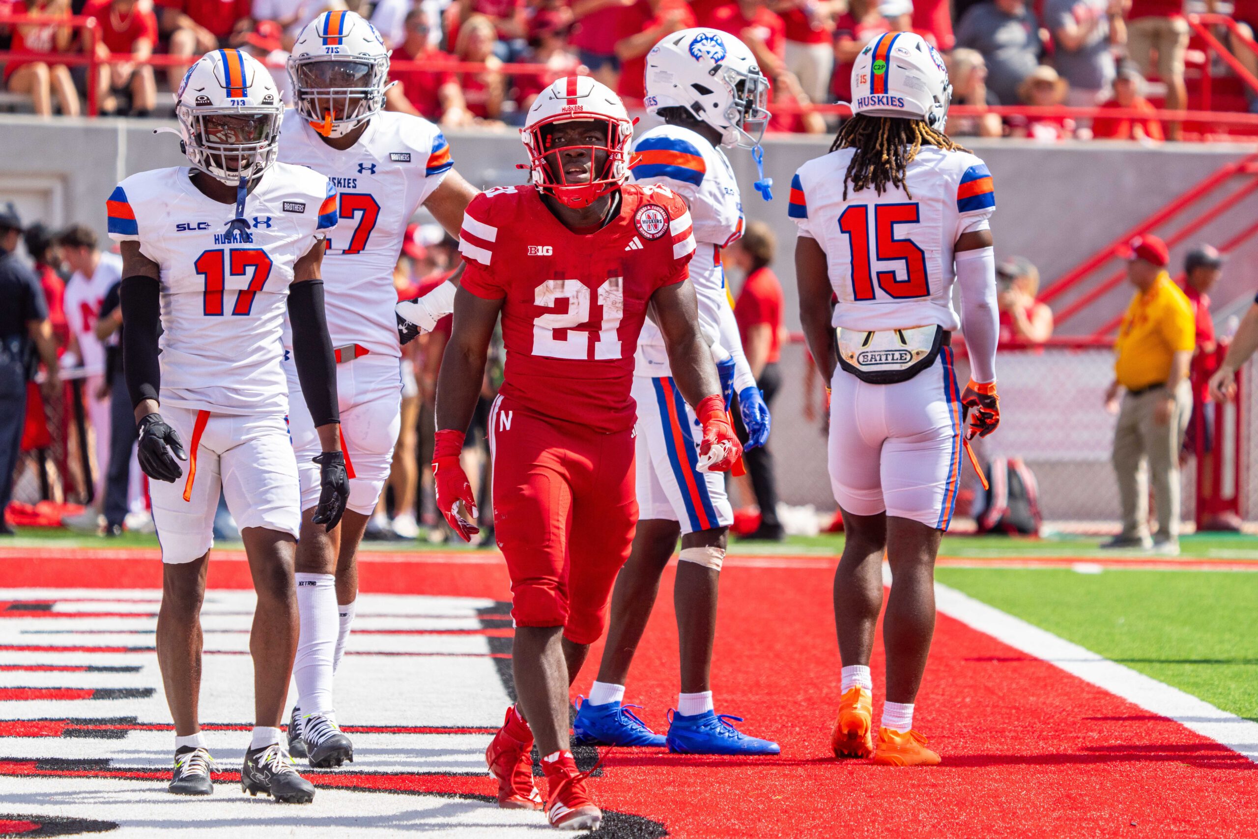 Sep 13, 2025; Lincoln, Nebraska, USA; Nebraska Cornhuskers running back Emmett Johnson (21) walks off after scoring against the Houston Christian Huskies during the second quarter at Memorial Stadium. Mandatory Credit: Dylan Widger-Imagn Images