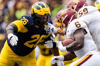 Michigan defensive lineman Rayshaun Benny (26) tries to tackle Central Michigan running back Trey Cornist (6) during the second half at Michigan Stadium in Ann Arbor on Saturday, Sept. 13, 2025.
