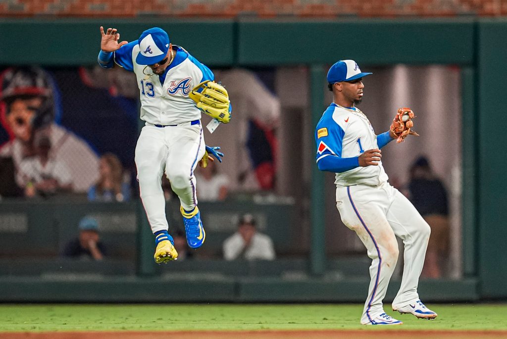 Sep 13, 2025; Cumberland, Georgia, USA; Atlanta Braves right fielder Ronald Acuna Jr (13) and second baseman Ozzie Albies (1) avoid a collision after Albies catches a pop up against the Houston Astros during the ninth inning at Truist Park. Mandatory Credit: Dale Zanine-Imagn Images