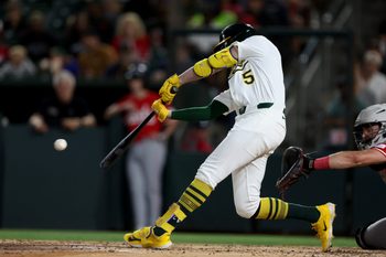 Sep 13, 2025; West Sacramento, California, USA; Athletics shortstop Jacob Wilson (5) hits a RBI ground rule double against the Cincinnati Reds during the third inning at Sutter Health Park. Mandatory Credit: Dennis Lee-Imagn Images