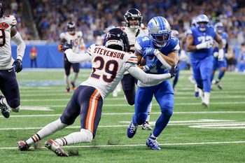 Sep 14, 2025; Detroit, Michigan, USA; Detroit Lions wide receiver Amon-Ra St. Brown (14) carries the ball defended by Chicago Bears cornerback Tyrique Stevenson (29) during the first quarter at Ford Field. Mandatory Credit: David Reginek-Imagn Images