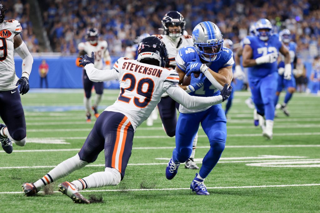 Sep 14, 2025; Detroit, Michigan, USA; Detroit Lions wide receiver Amon-Ra St. Brown (14) carries the ball defended by Chicago Bears cornerback Tyrique Stevenson (29) during the first quarter at Ford Field. Mandatory Credit: David Reginek-Imagn Images