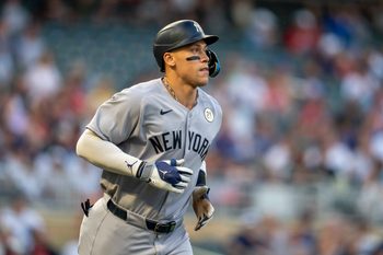 Sep 15, 2025; Minneapolis, Minnesota, USA; New York Yankees right fielder Aaron Judge (99) runs to first base after drawing a walk against the Minnesota Twins in the first inning at Target Field. Mandatory Credit: Jesse Johnson-Imagn Images