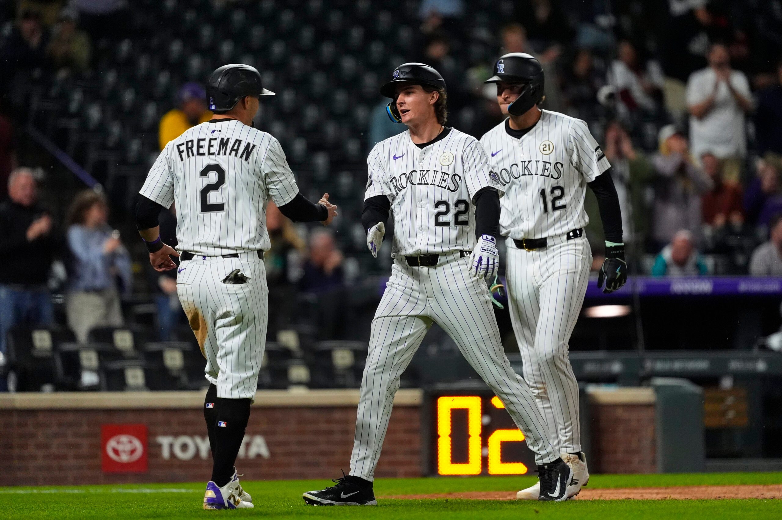 Sep 16, 2025; Denver, Colorado, USA; Colorado Rockies right fielder Mickey Moniak (22) celebrates his three run home run in the eighth inning with designated hitter fielder Tyler Freeman (2) and third baseman Kyle Karros (12) against the Miami Marlins at Coors Field. Mandatory Credit: Ron Chenoy-Imagn Images