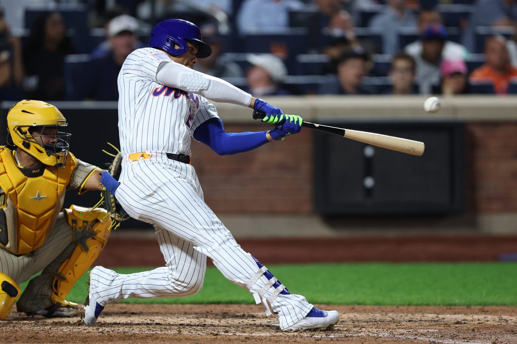Sep 17, 2025; New York City, New York, USA; New York Mets right fielder Juan Soto (22) hits a home run during the fifth inning against the San Diego Padres at Citi Field. Mandatory Credit: Vincent Carchietta-Imagn Images
