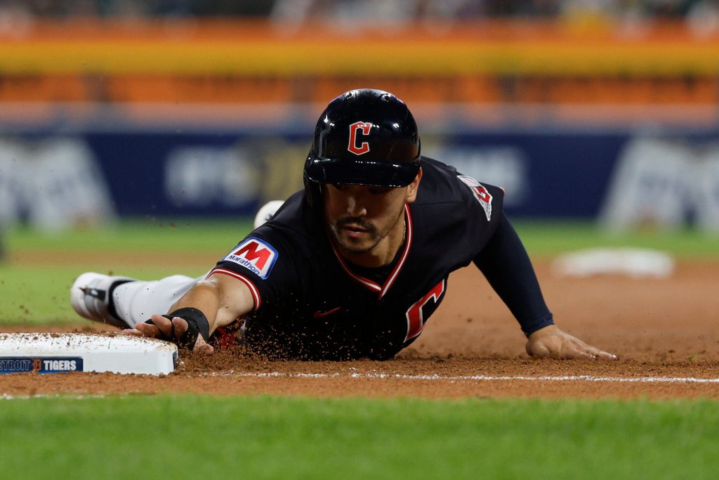 Sep 17, 2025; Detroit, Michigan, USA; Cleveland Guardians left fielder Steven Kwan (38) slides into first base after trying to steal second base during the eighth inning against the Detroit Tigers at Comerica Park. Mandatory Credit: Brian Bradshaw Sevald-Imagn Images