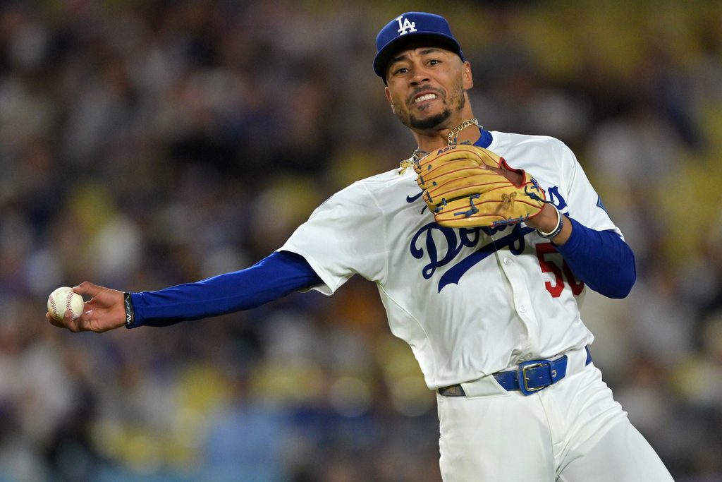 Sep 17, 2025; Los Angeles, California, USA; Los Angeles Dodgers shortstop Mookie Betts (50) makes a throw to first base against the Philadelphia Phillies in the second inning at Dodger Stadium. Mandatory Credit: Jayne Kamin-Oncea-Imagn Images