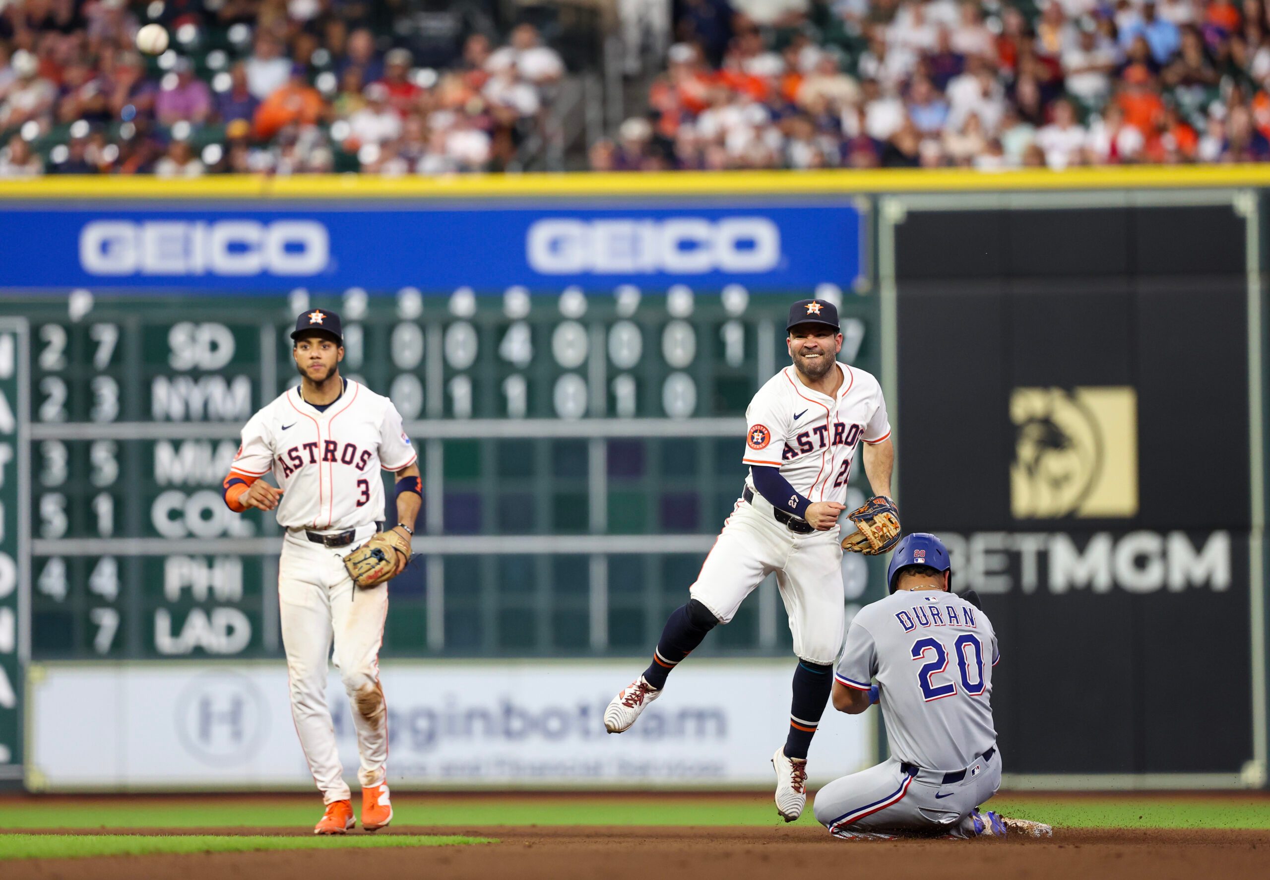 Sep 17, 2025; Houston, Texas, USA; Houston Astros second baseman Jose Altuve (27) forces Texas Rangers shortstop Ezequiel Duran (20) out at second base and turns the double play in the eighth inning at Daikin Park. Mandatory Credit: Thomas Shea-Imagn Images