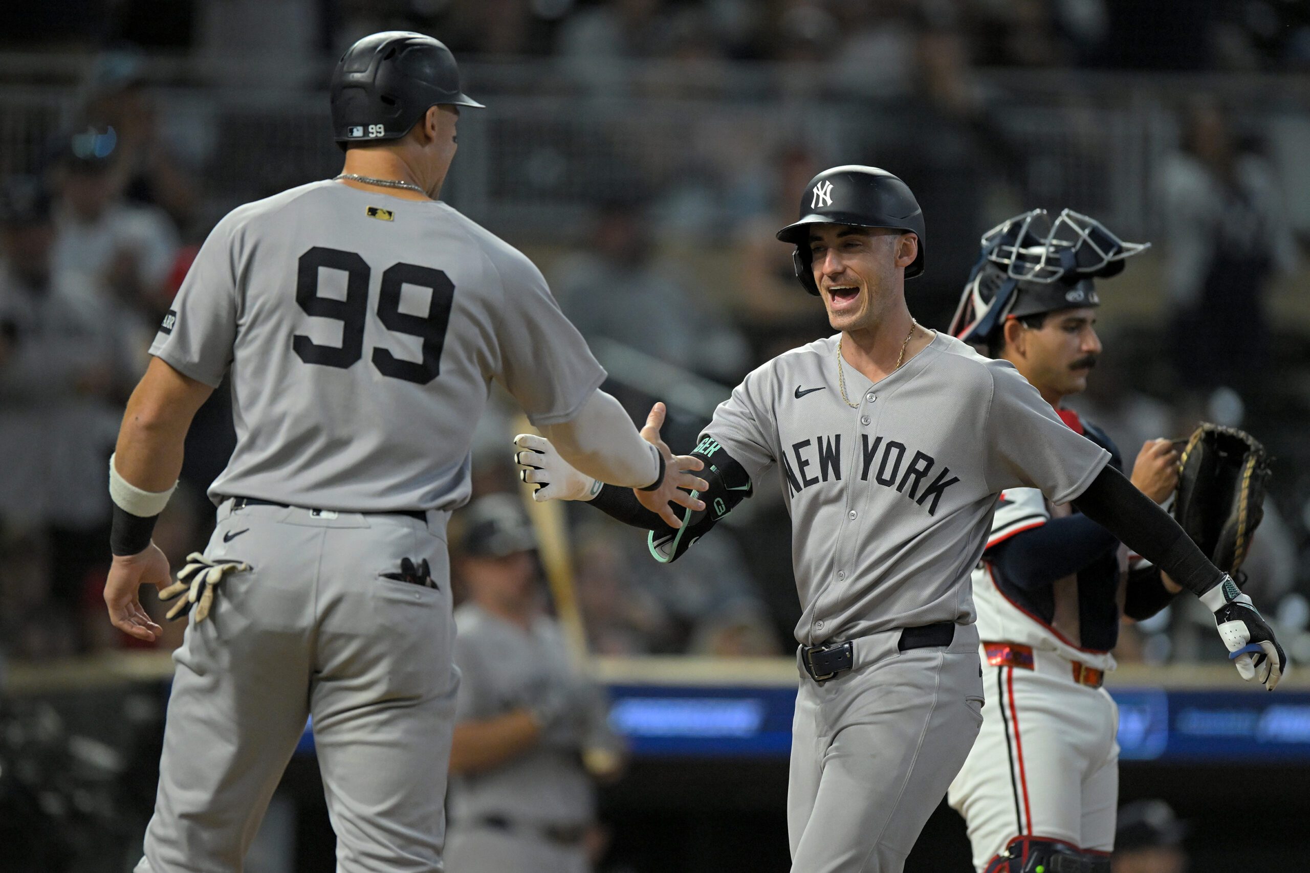 Sep 17, 2025; Minneapolis, Minnesota, USA;  New York Yankees designated hitter Aaron Judge (99) congratulates outfielder Cody Bellinger (35) on his two-run home run against the Minnesota Twins during the ninth inning at Target Field. Mandatory Credit: Nick Wosika-Imagn Images