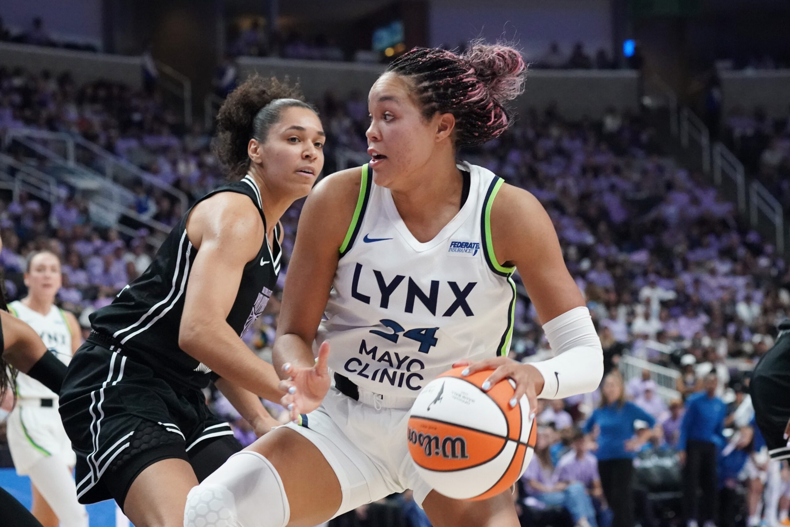 Sep 17, 2025; San Jose, California, USA; Minnesota Lynx forward Napheesa Collier (24) dribbles against Golden State Valkyries forward Janelle Salaun (13) in the third quarter in game two of round one for the 2025 WNBA Playoffs at SAP Center. Mandatory Credit: David Gonzales-Imagn Images